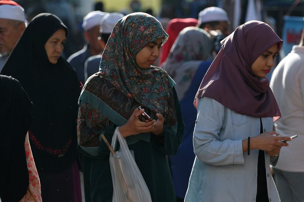 Muslim women wearing 'tudung' or headscarves shop in Kota Bharu